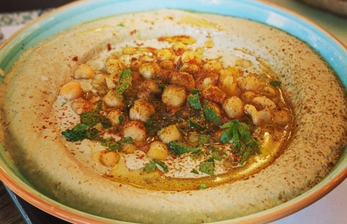 A plate of Hummus with garbanzo beans and paprika
