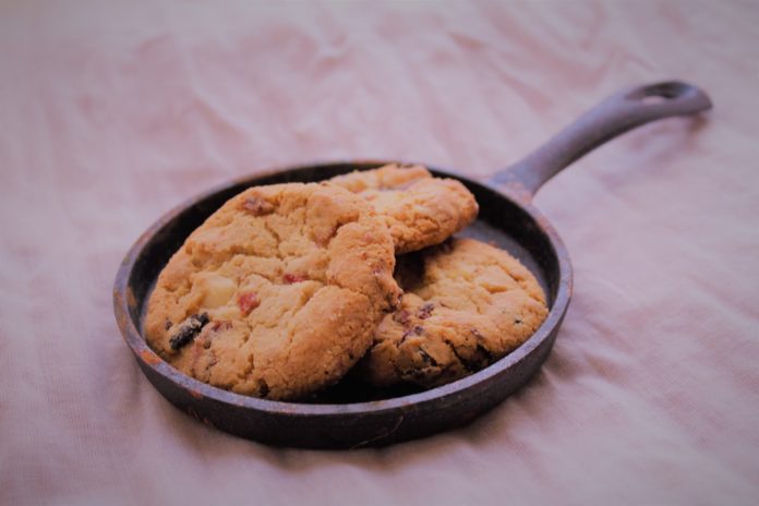 Tasty cookies being held in a cast iron pan