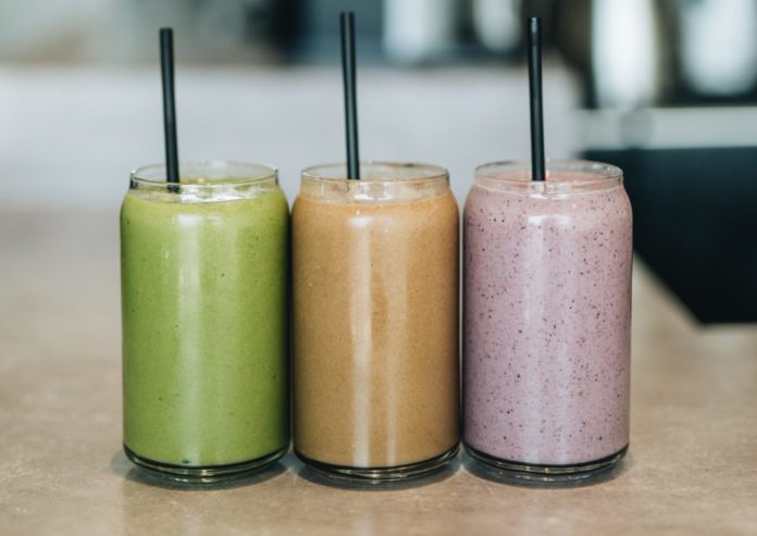 Three different colored smoothies sitting in a row