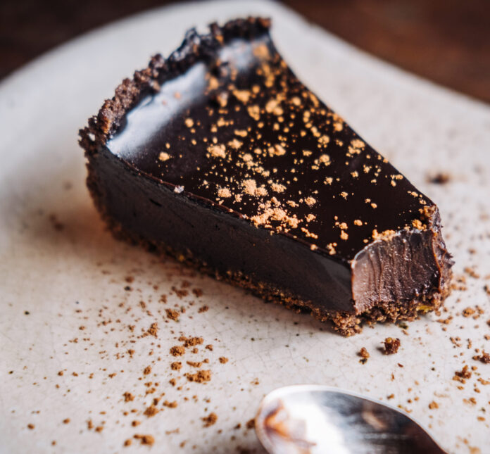 Slice of raw vegan rich dark chocolate cake