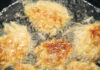 The Perfect Latkes Recipe to Make for Hanukkah This Year Closeup view of potato pancakes, or "latkes", frying in oil for Hanukkah.