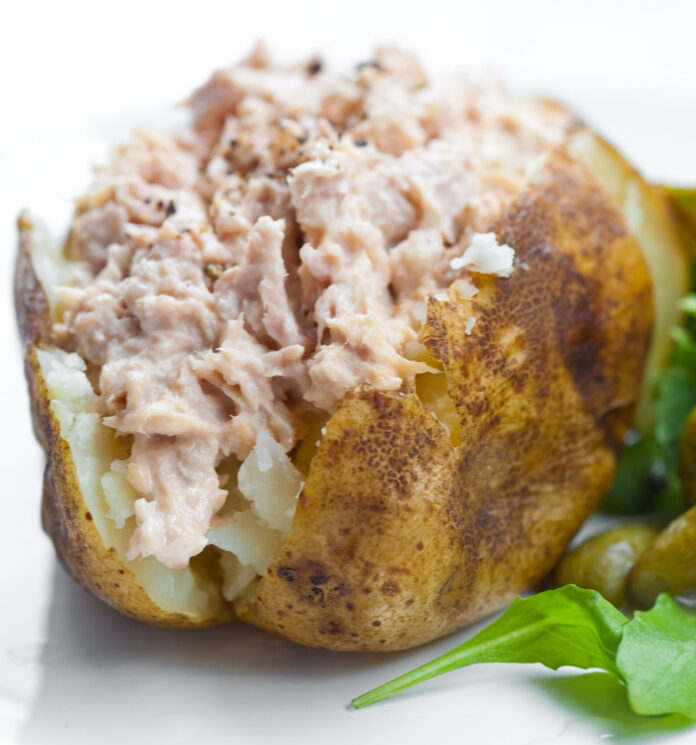 Delicious freshly baked potato served with tuna and salad