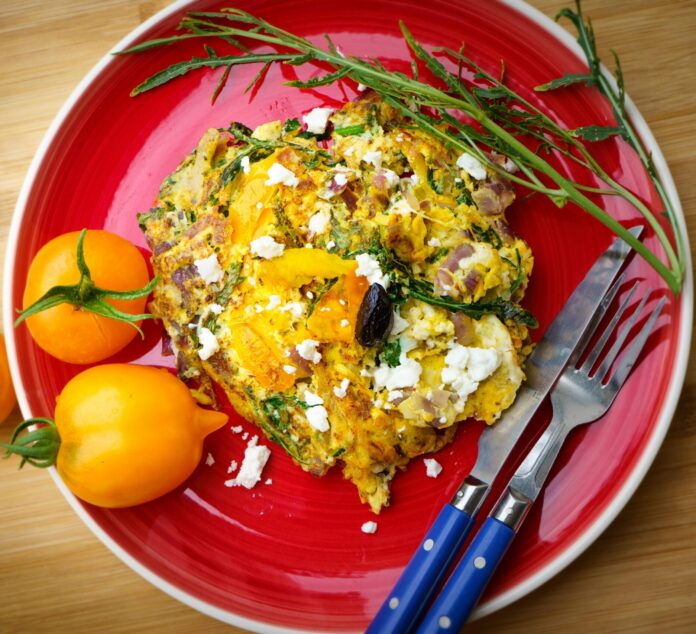 Frittata on a plate with orange tomatoes